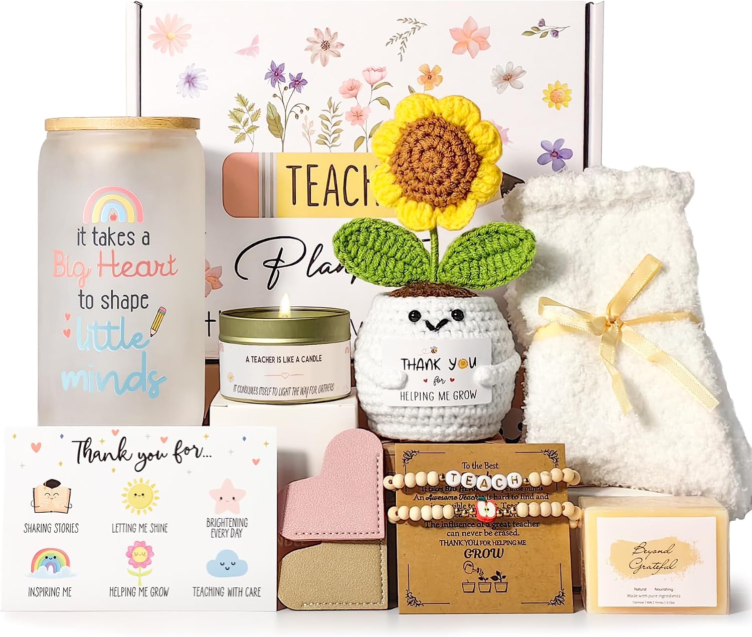 Teacher appreciation gift set with frosted glass 'It takes a big heart to shape little minds' travel cup, crochet sunflower, wooden bead bracelet, heart bookmarks, lavender candle, handmade soap, cozy socks, and thank-you card arranged in a floral gift box