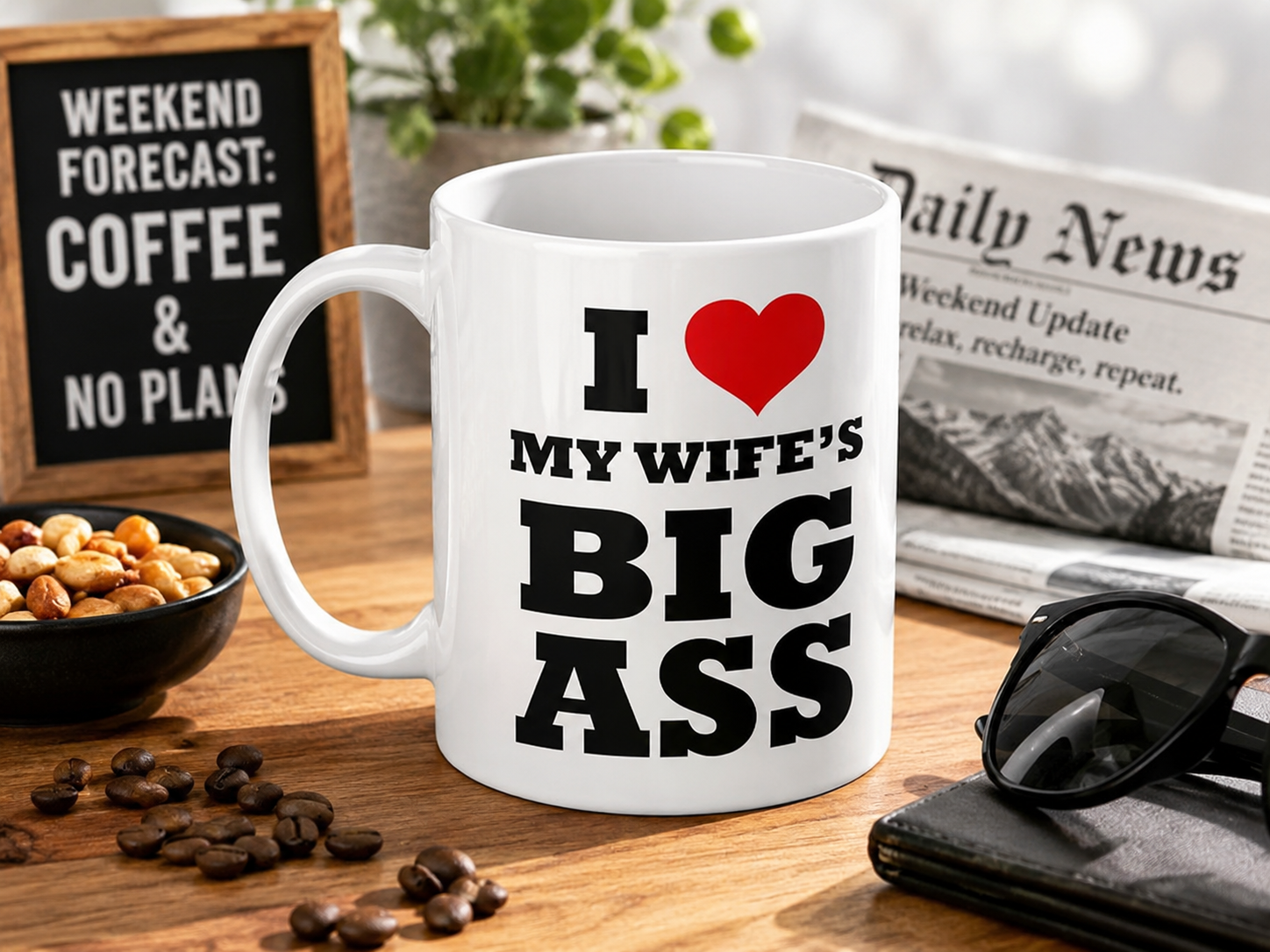 Bold black-lettered 'I Love My Wife's Big Ass' funny playful ceramic coffee mug gift from wife with red heart on wooden desk