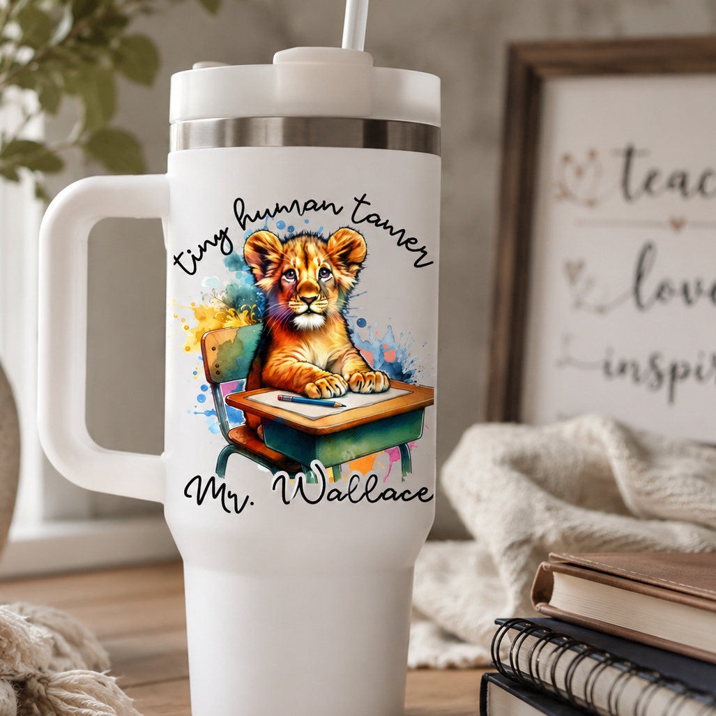White 40 oz insulated teacher tumbler with handle featuring a watercolor lion cub at a desk and 'Tiny Human Tamer Mr. Wallace' personalized daycare teacher gift design