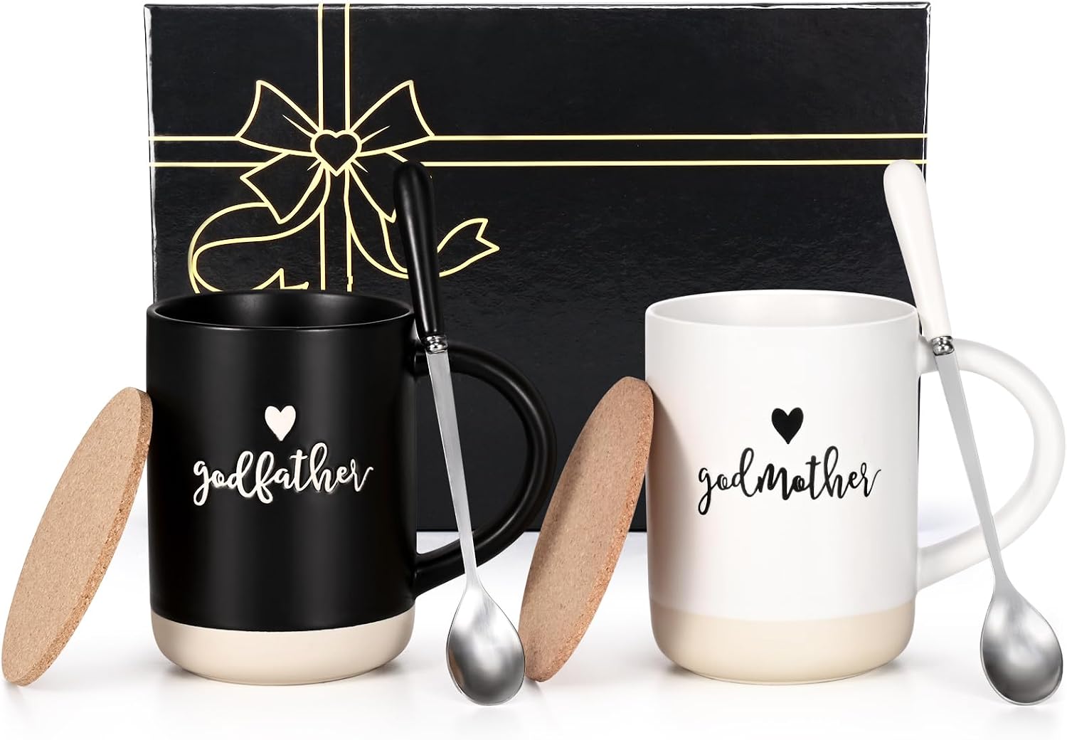 Matte black godfather mug and matte white godmother mug with cork lids and stirring spoons, in front of a black gift box printed with a gold bow