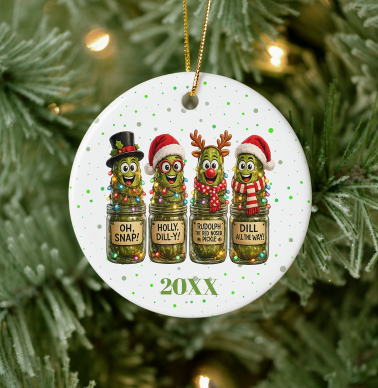 Round white ceramic ornament with four cartoon pickles in jars wearing holiday hats, labeled Oh Snap, Holly Dill-y, Rudolph the Red Nosed Pickle, and Dill All The Way, above a customizable year