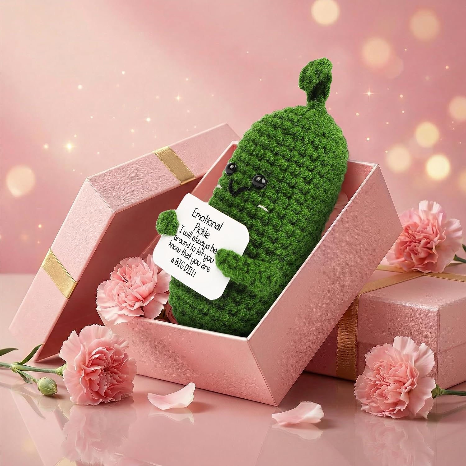 Small crocheted green pickle with a stitched smile holding a card reading Emotional Pickle, I will always be around to let you know that you are a BIG DILL, in a pink gift box