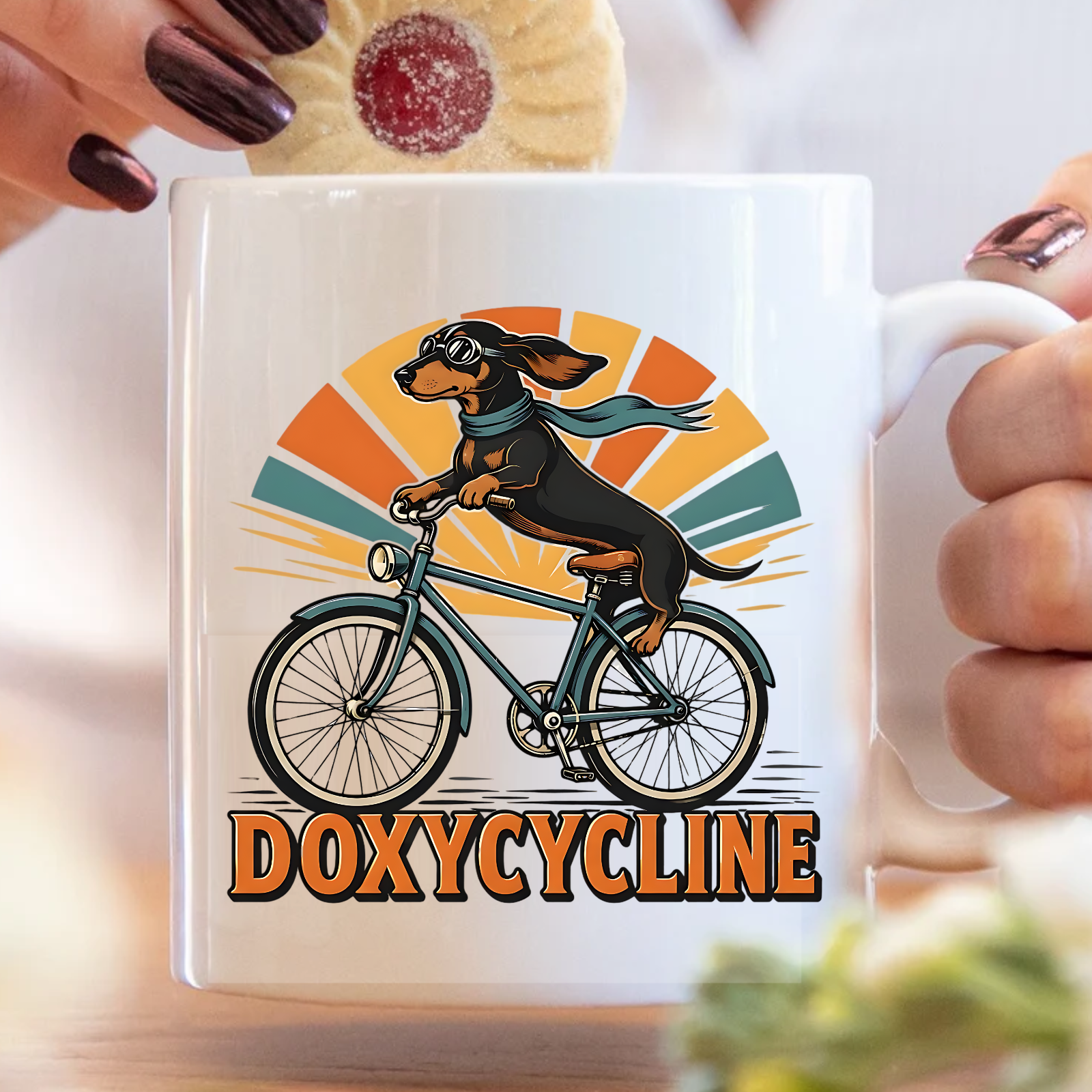 White ceramic mug printed with a retro illustration of a dachshund in goggles riding a bicycle above the word DOXYCYCLINE