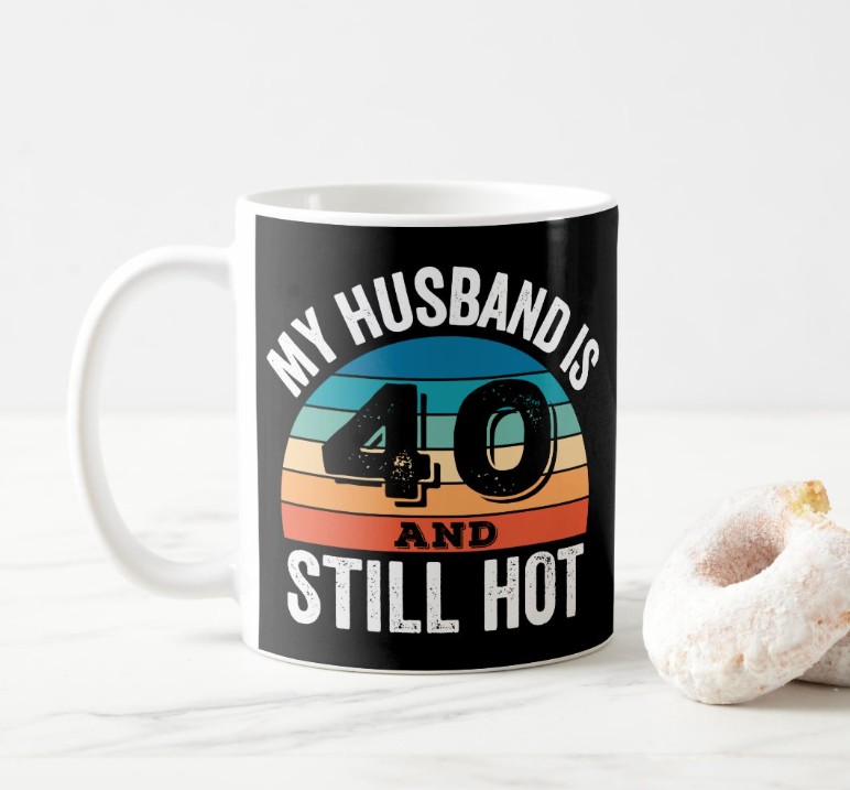 Funny custom 'My Husband Is 40 and Still Hot' retro sunset milestone birthday coffee mug gift from wife on marble surface