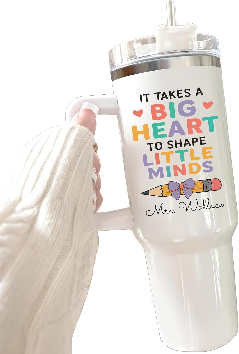 White handled 40 oz teacher travel mug tumbler with 'It Takes A Big Heart To Shape Little Minds' colorful lettering, small bow-and-pencil illustration, and personalized 'Mrs. Wallace' name in script